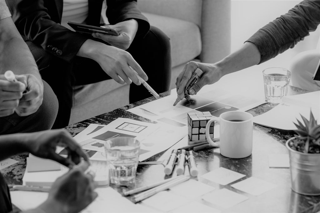 Team sketching ideas around a meeting table