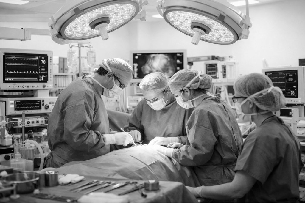 Surgeons operating in a modern operating theatre